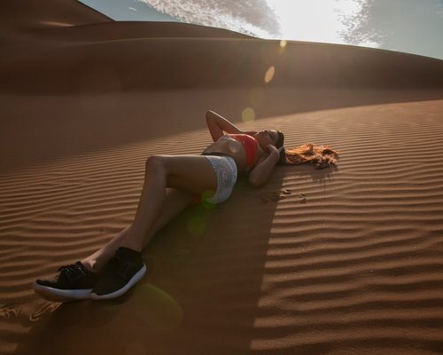 Active man stretching in sunlight desert environment